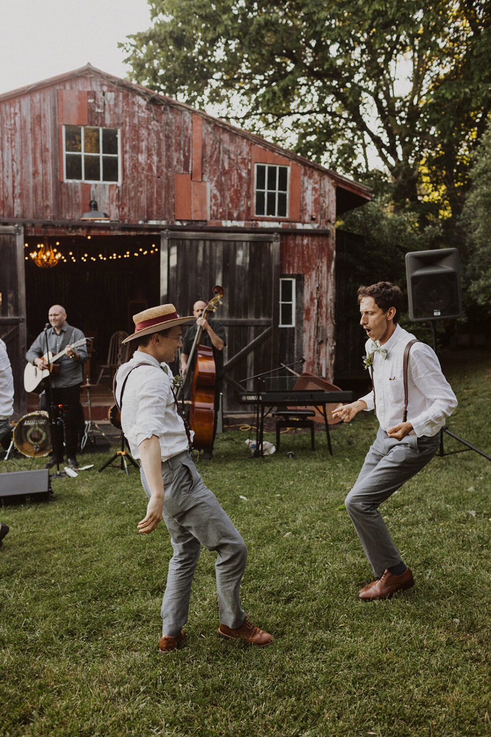 groomsmen dance together by barn 