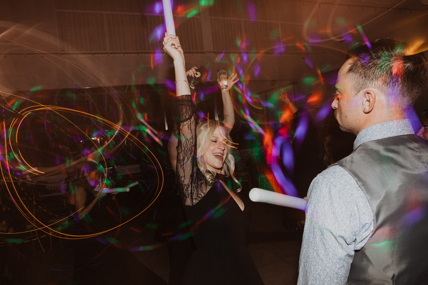 wedding guests dance with glowsticks 