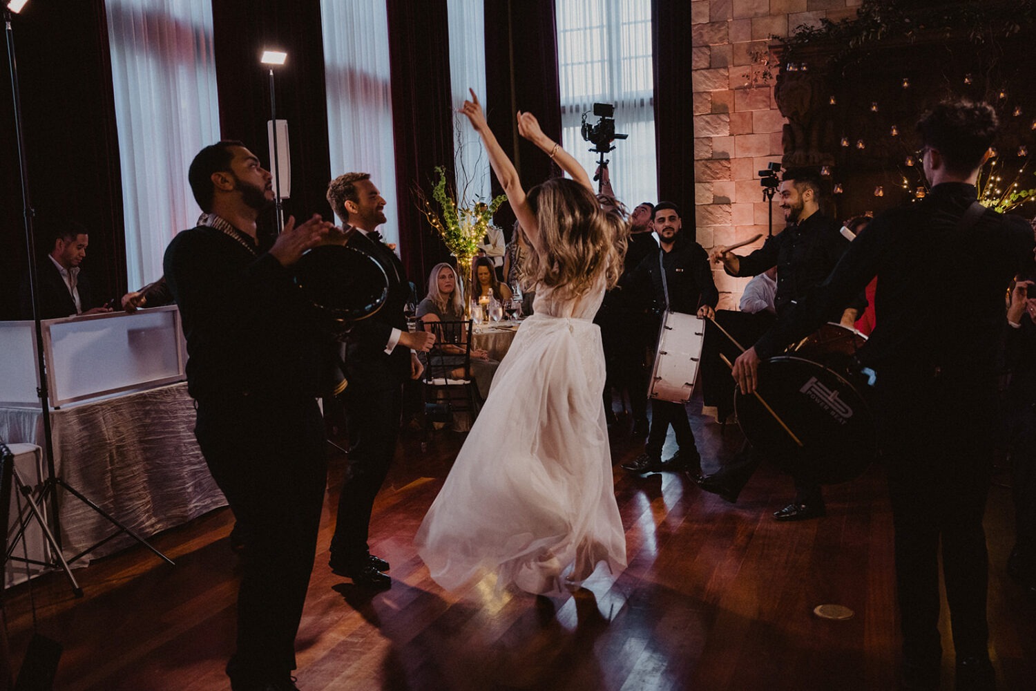 couple dances with band at wedding reception 