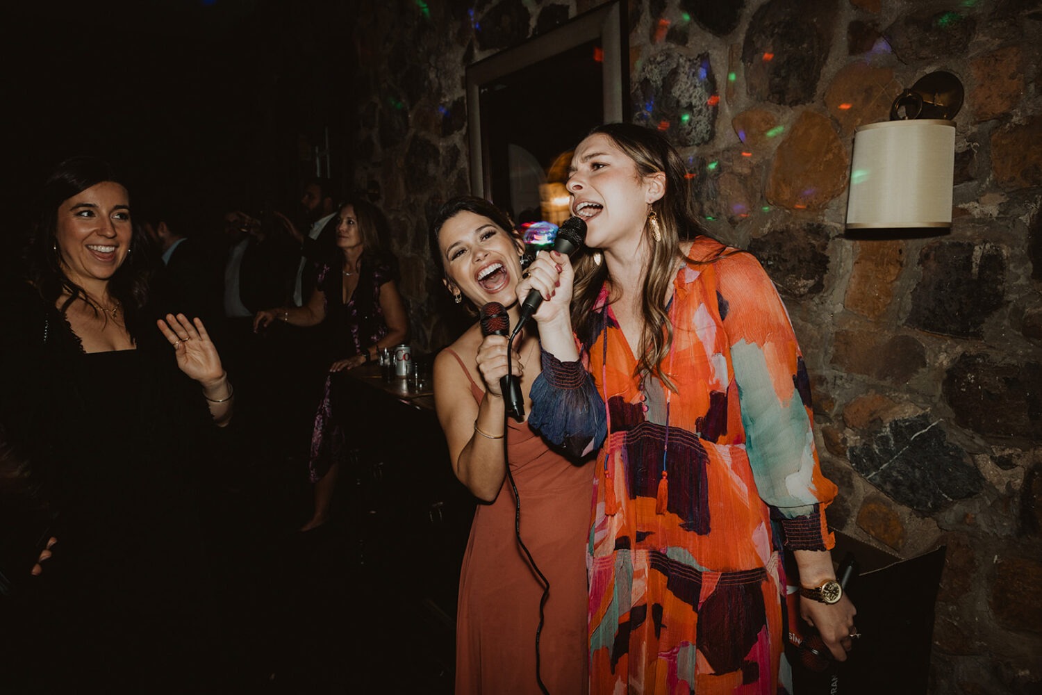 guests sing karaoke at wedding reception 