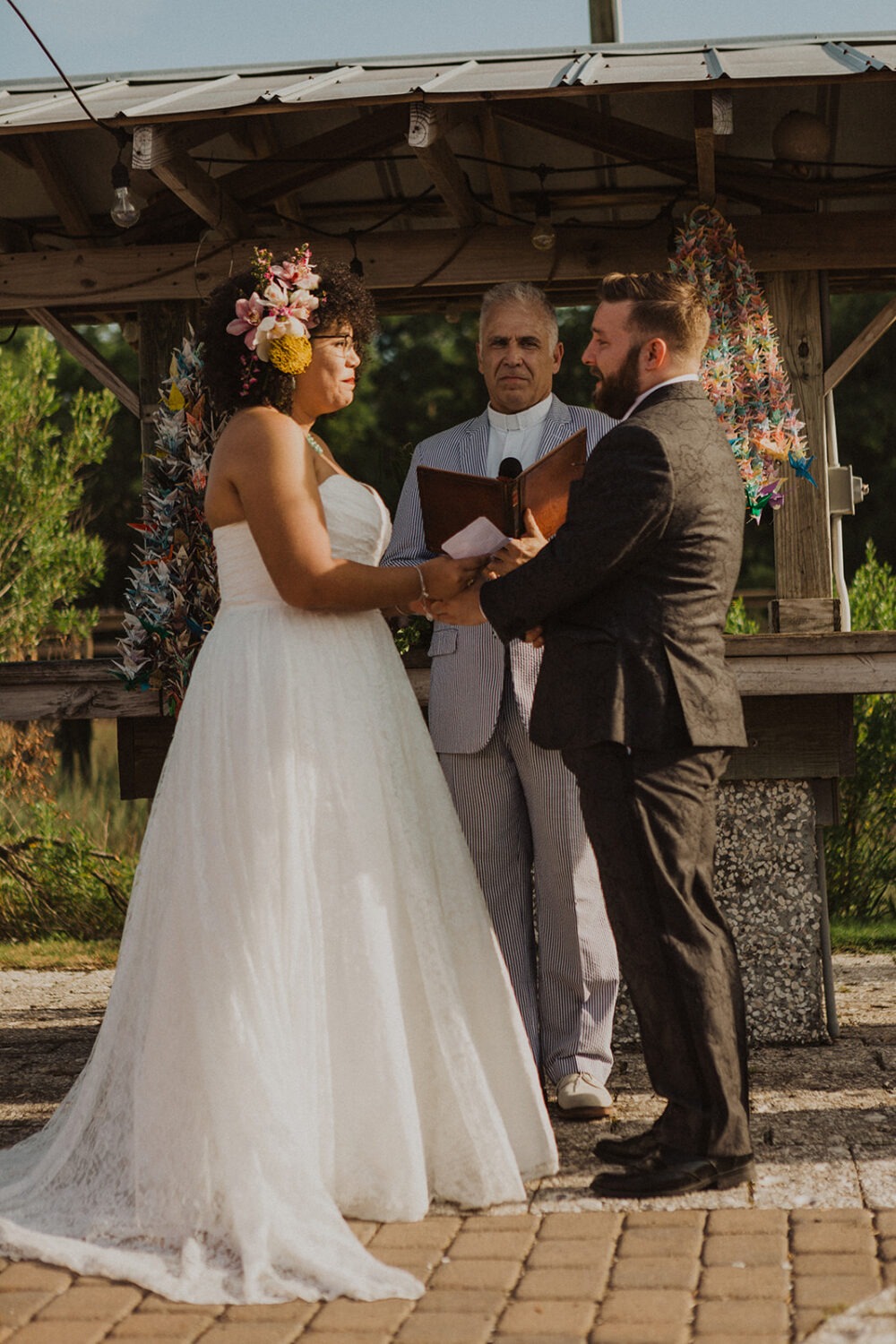 couple exchanges vows at waterfront wedding ceremony