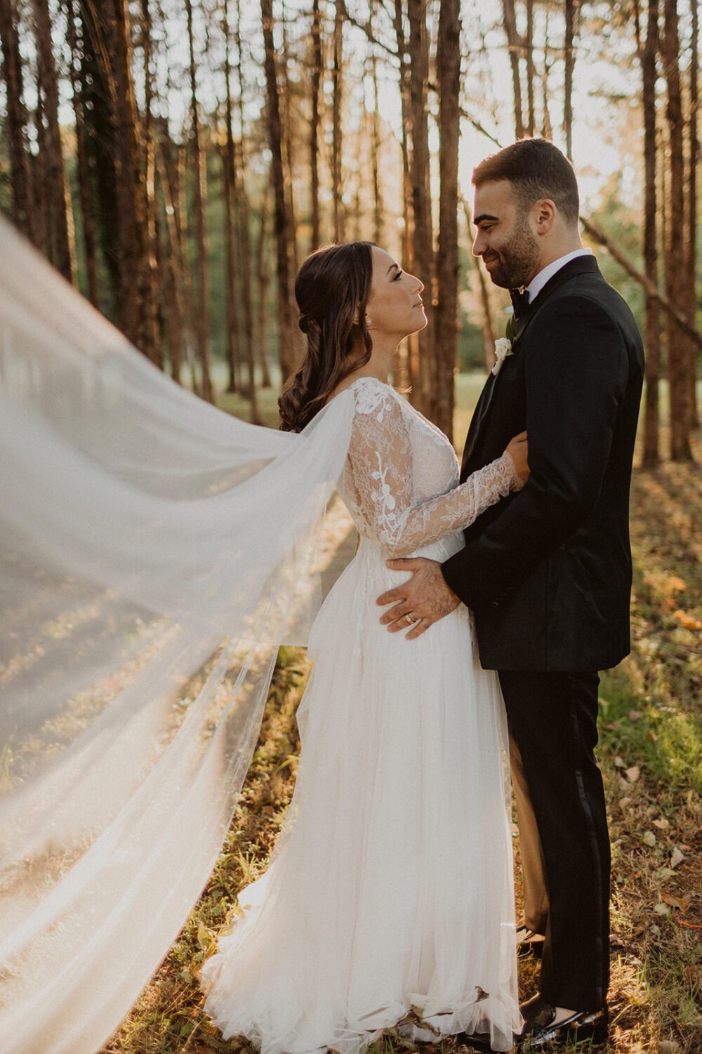 couple embraces in sunset woods at traditional Jewish wedding