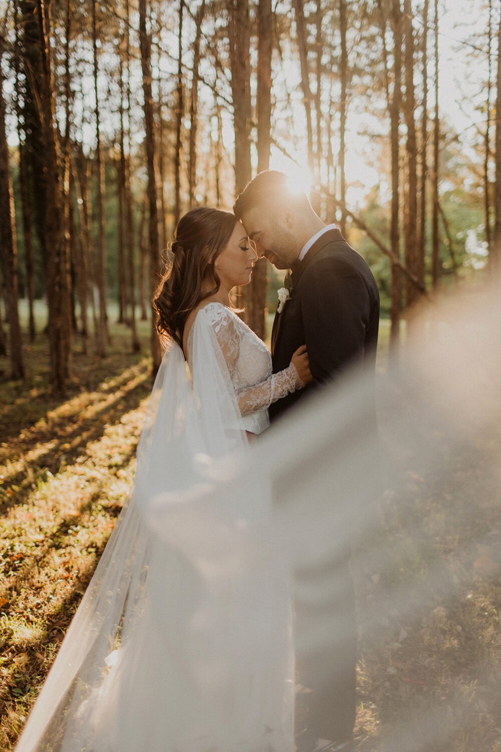 couple embraces in sunset woods at traditional Jewish wedding