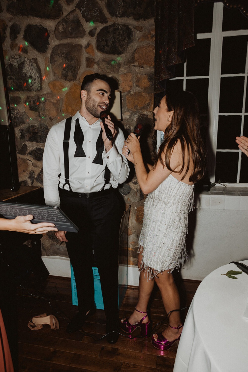 couple sings karaoke at wedding reception