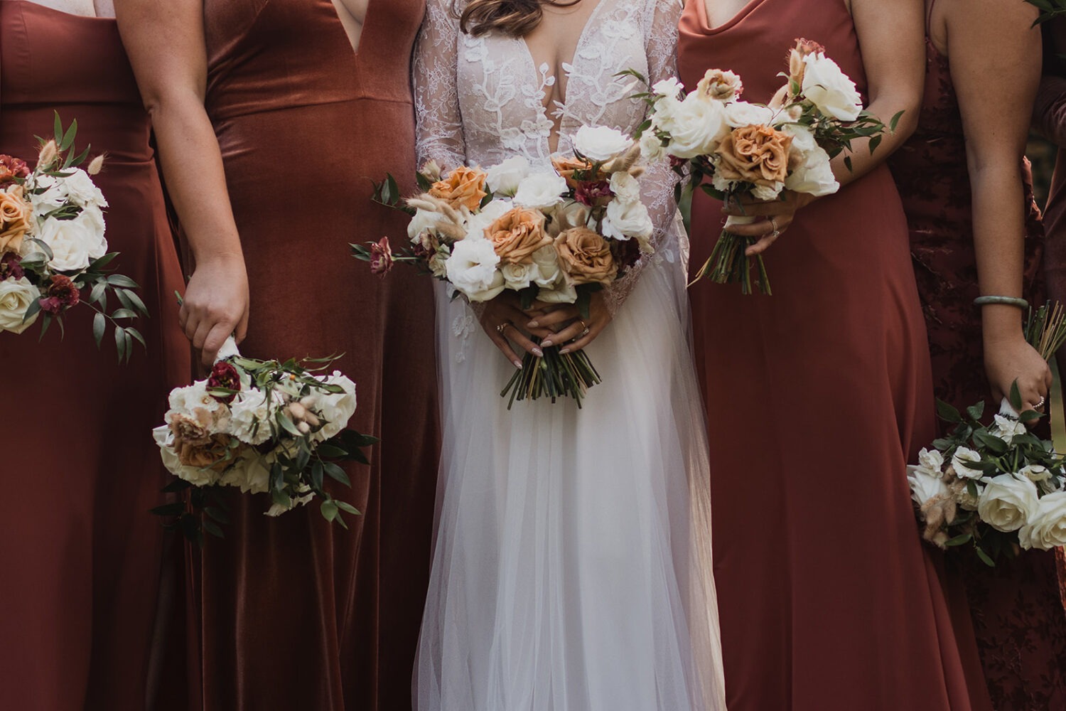 brides hold fall wedding bouquets at traditional Jewish wedding