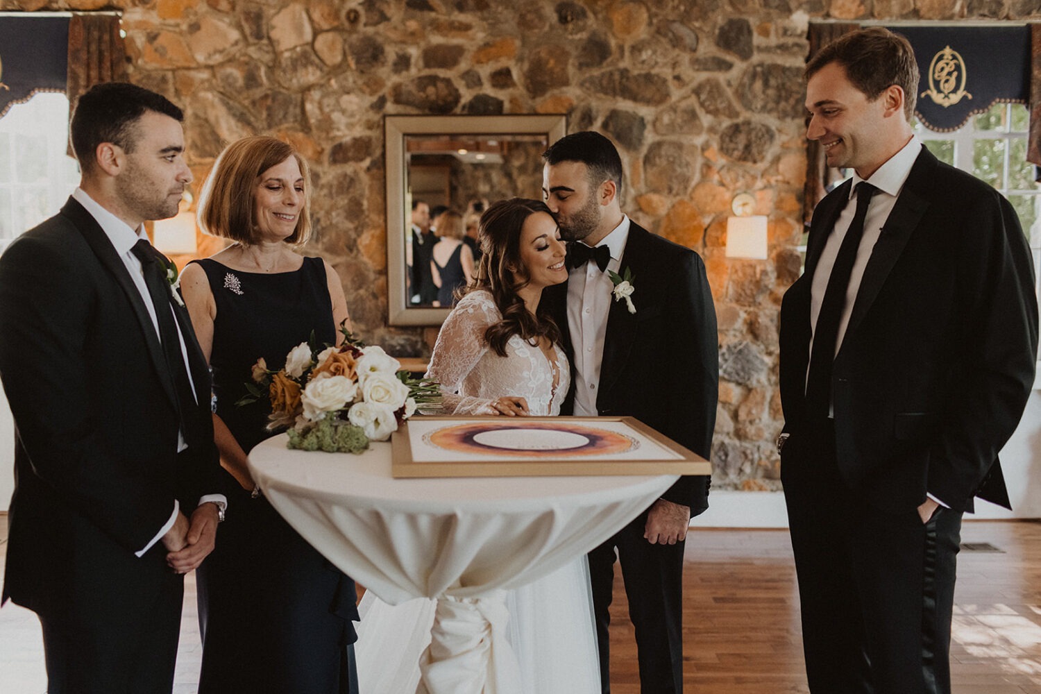 couple signs document at traditional Jewish wedding