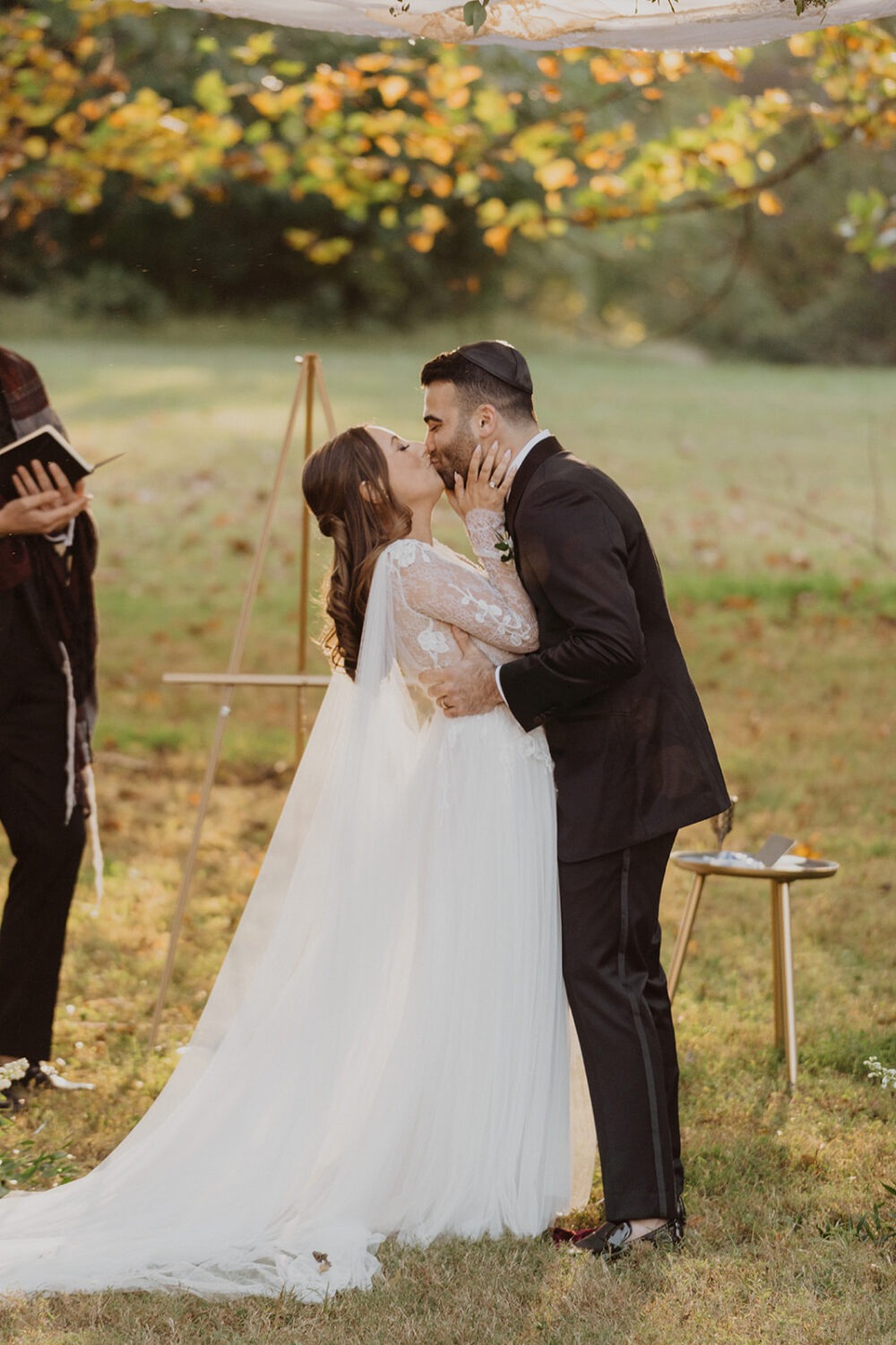 couple kisses at traditional Jewish wedding