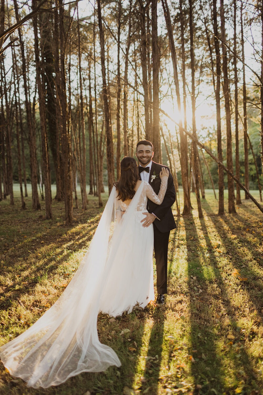 couple embraces in sunset woods at outdoor Virginia wedding
