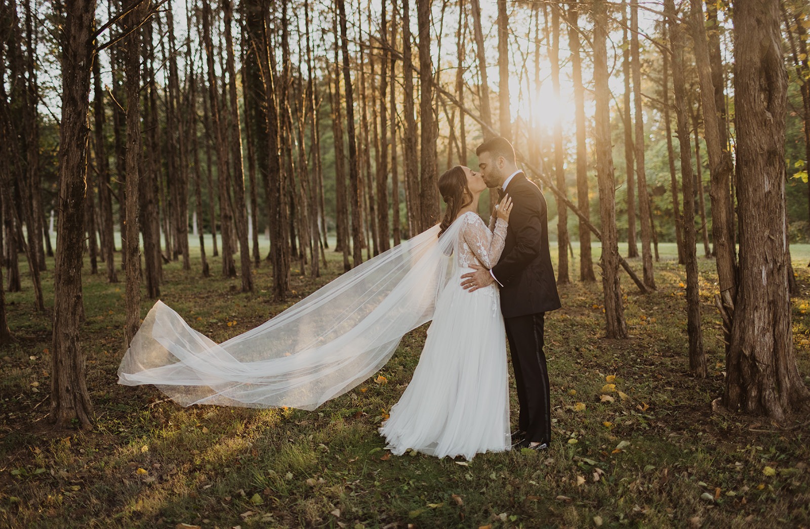 wedding couple kisses in sunset woods at Poplar Springs Manor