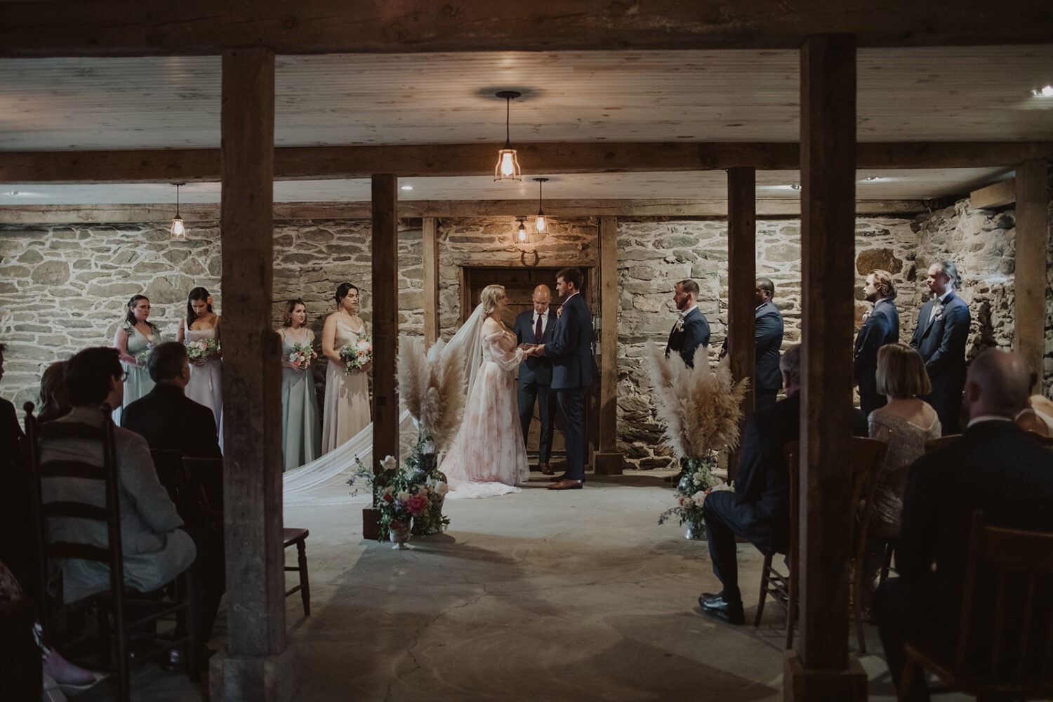 couple exchanges vows inside wedding barn