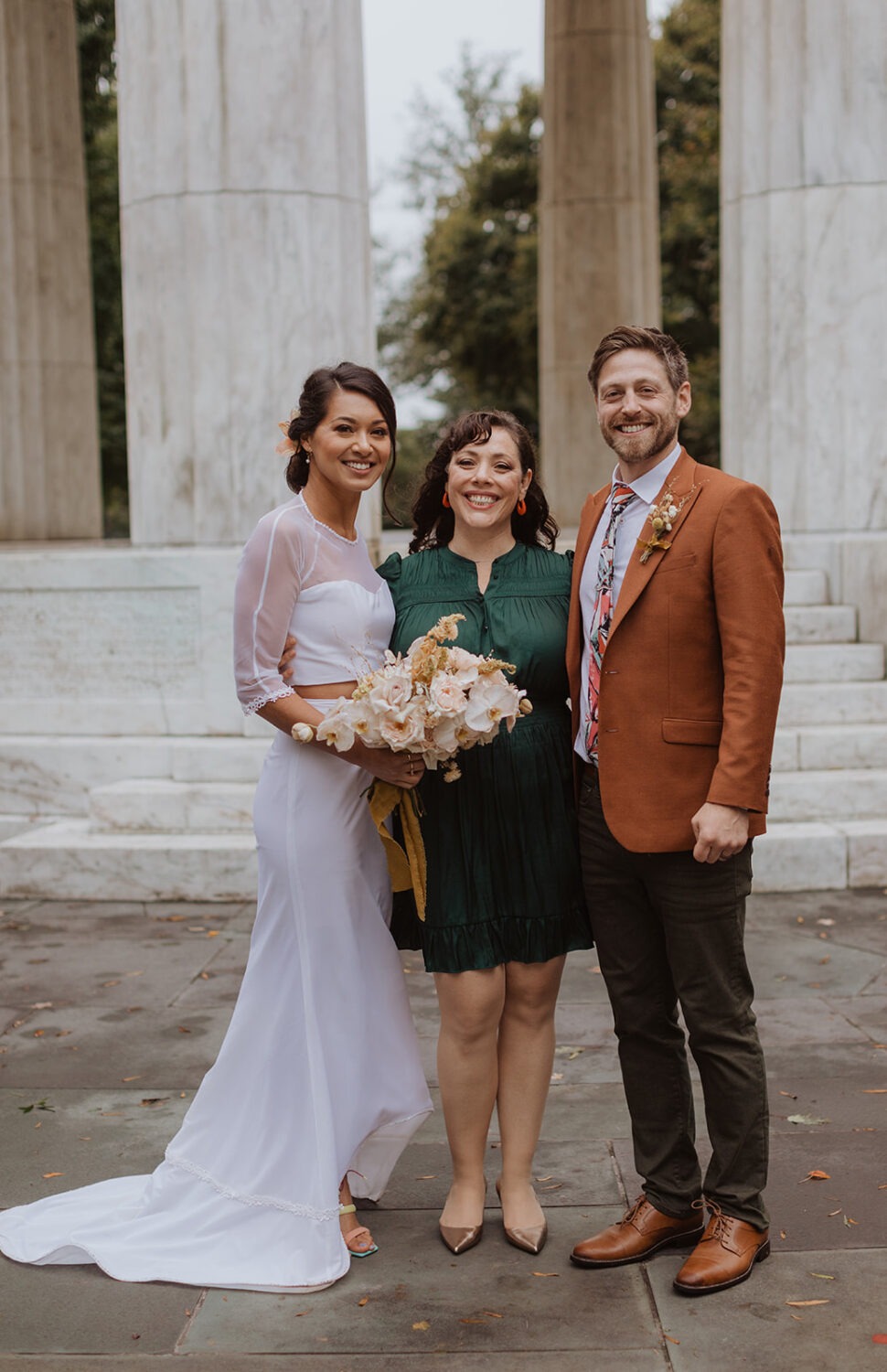 couple stands with wedding officiant at DC wedding