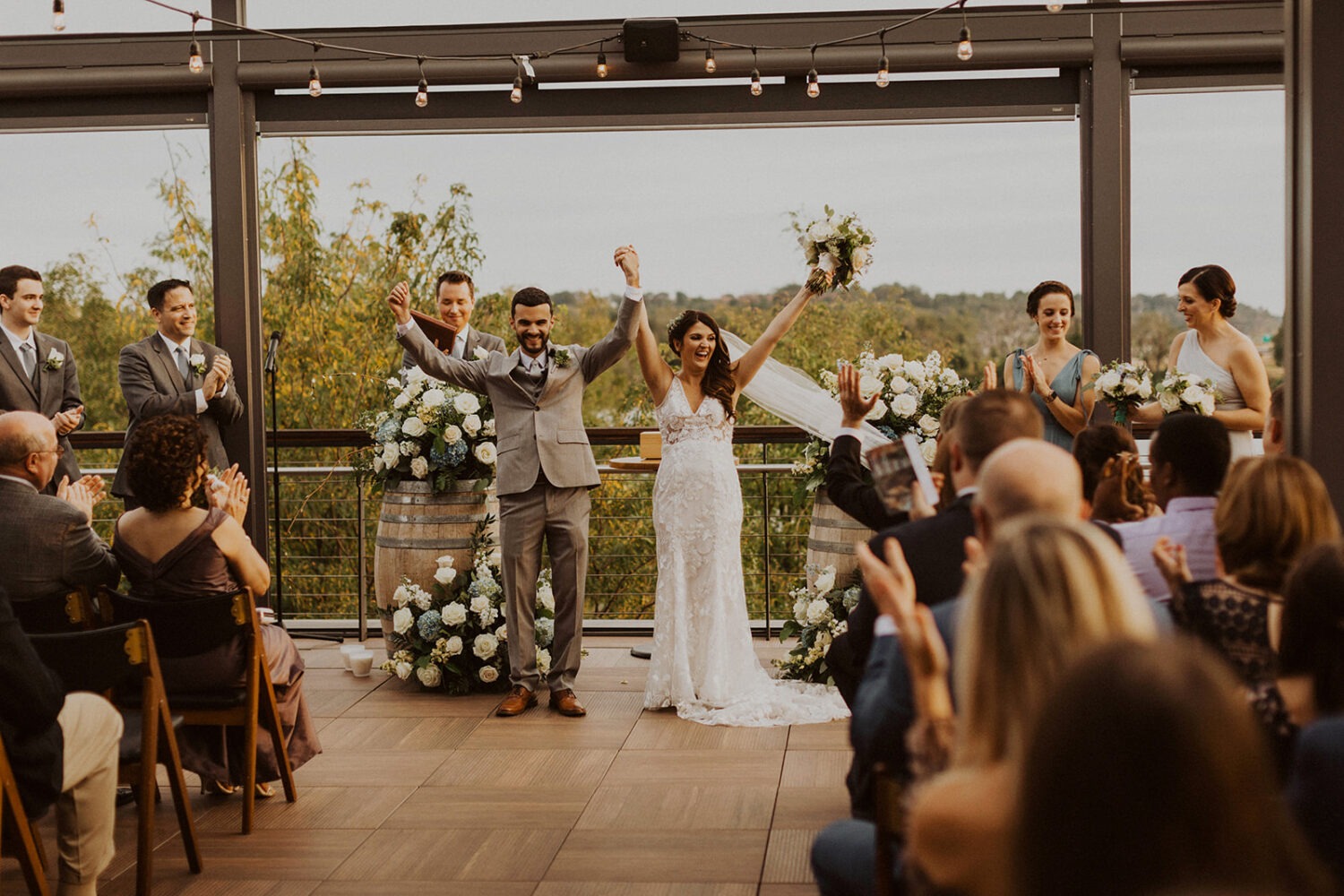 couple cheers during rooftop ceremony