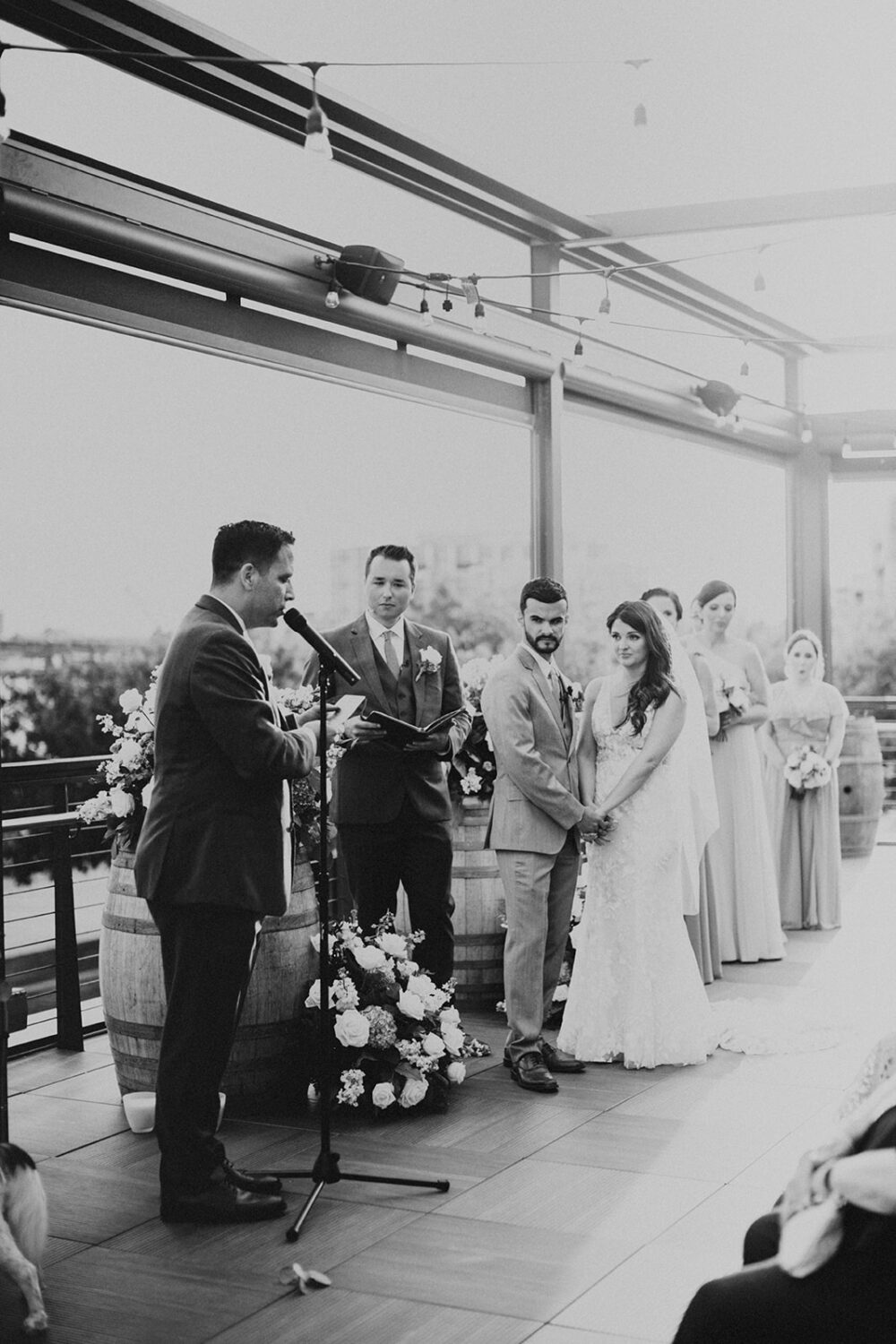 couple listens to reading at rooftop outdoor wedding ceremony