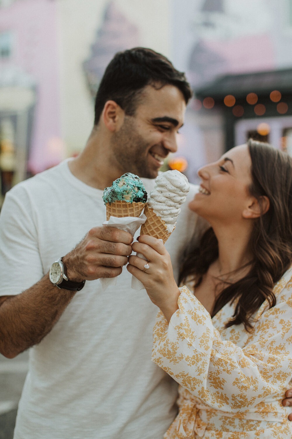 couple cheers ice cream cones at summer engagement photos