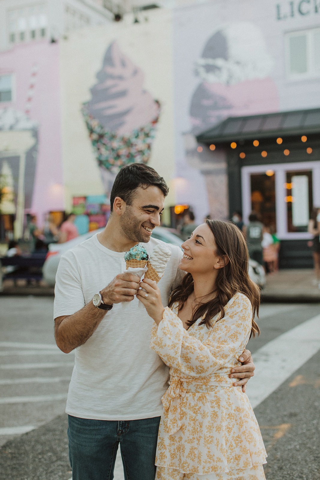 couple takes summer engagement photos at ice cream shop