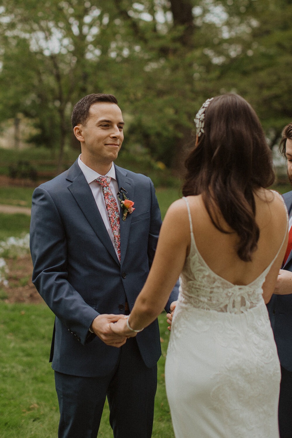 couple holds hands at park outdoor ceremony