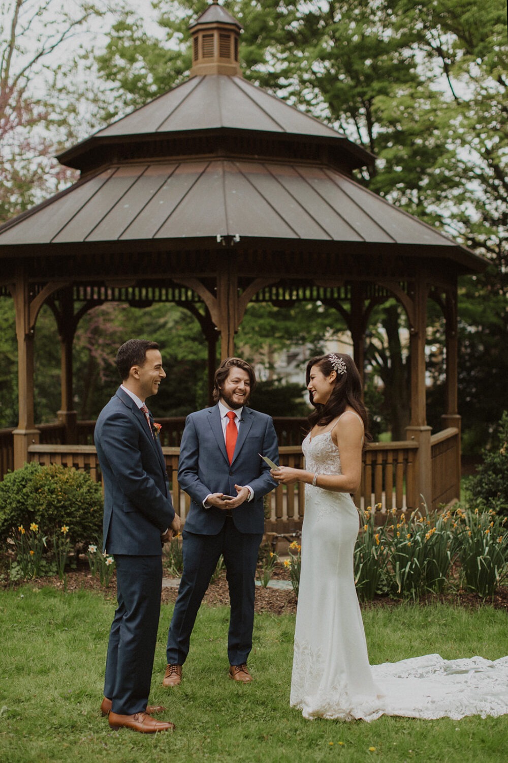 couple exchanges vows in park outside of gazebo