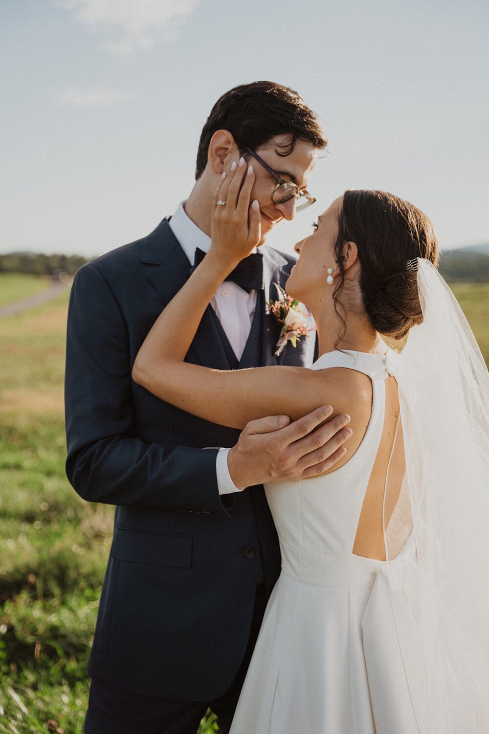 couple embraces at sunset during outdoor wedding 