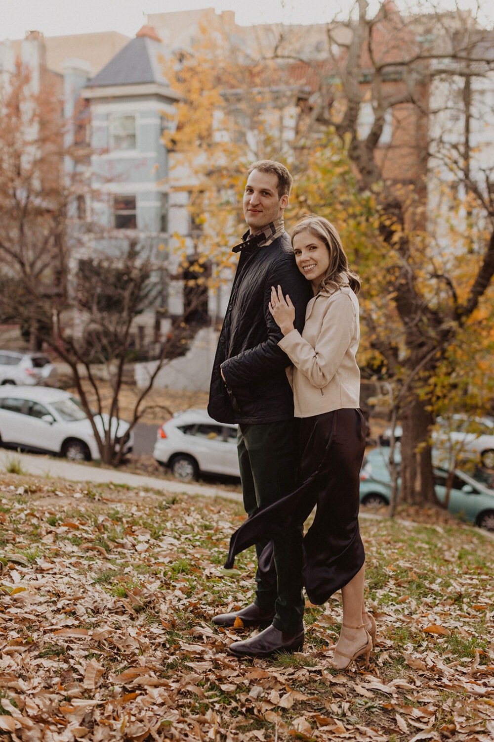 couple embraces each other at fall outdoor engagement session