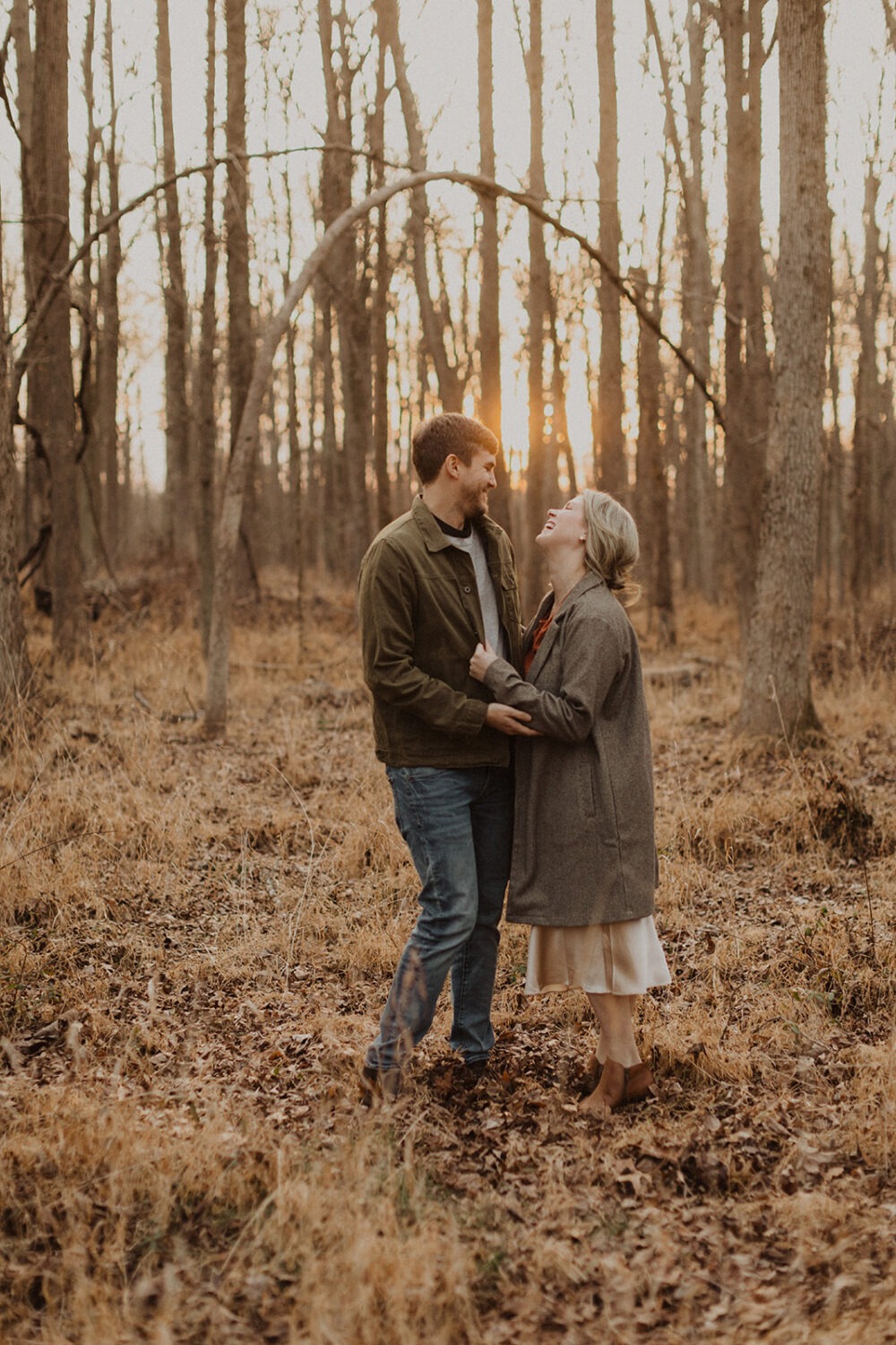 couples wear jackets with fall engagement shoot outfit