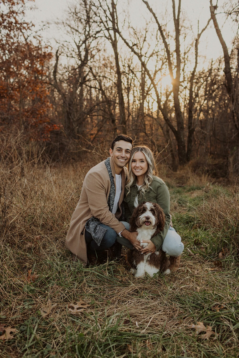 couple poses with dog wearing fall engagement shoot outfit 
