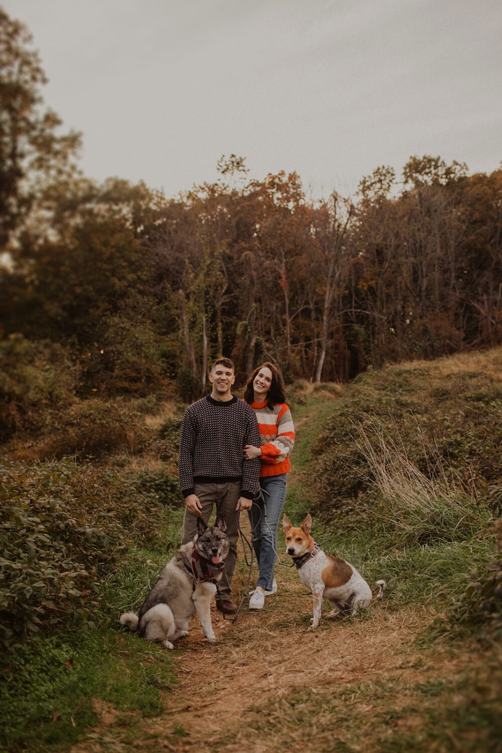 couple poses with dogs at outdoor DC engagement session
