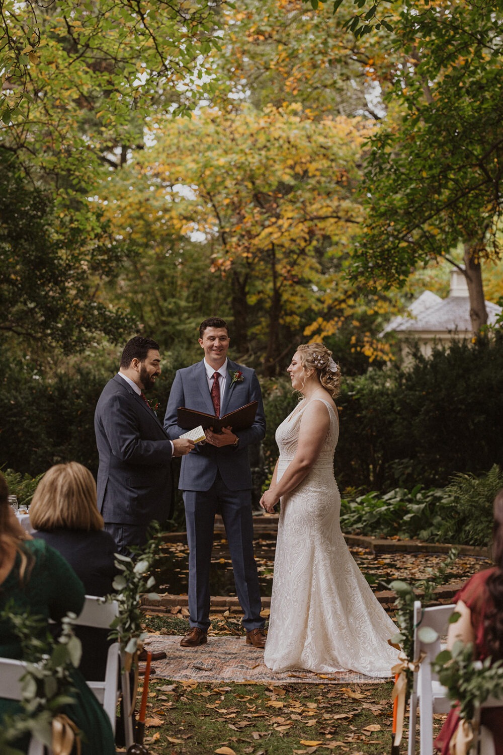 couple exchanges vows at fall backyard wedding