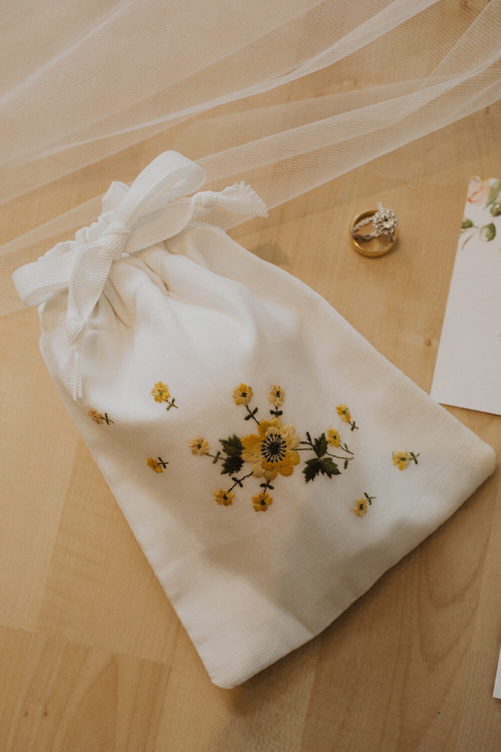 floral details on white wedding bag