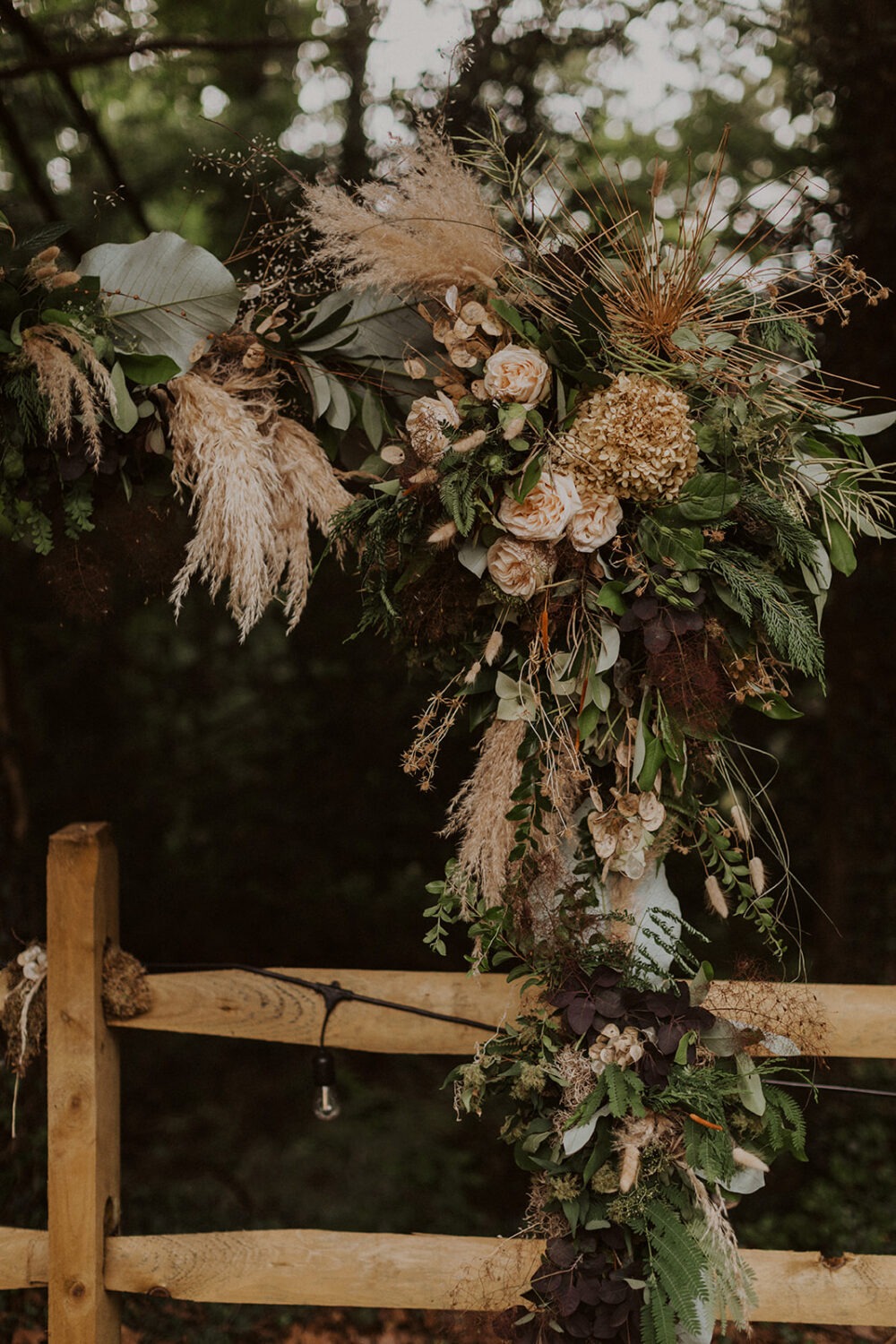boho dried flowers arch at backyard wedding