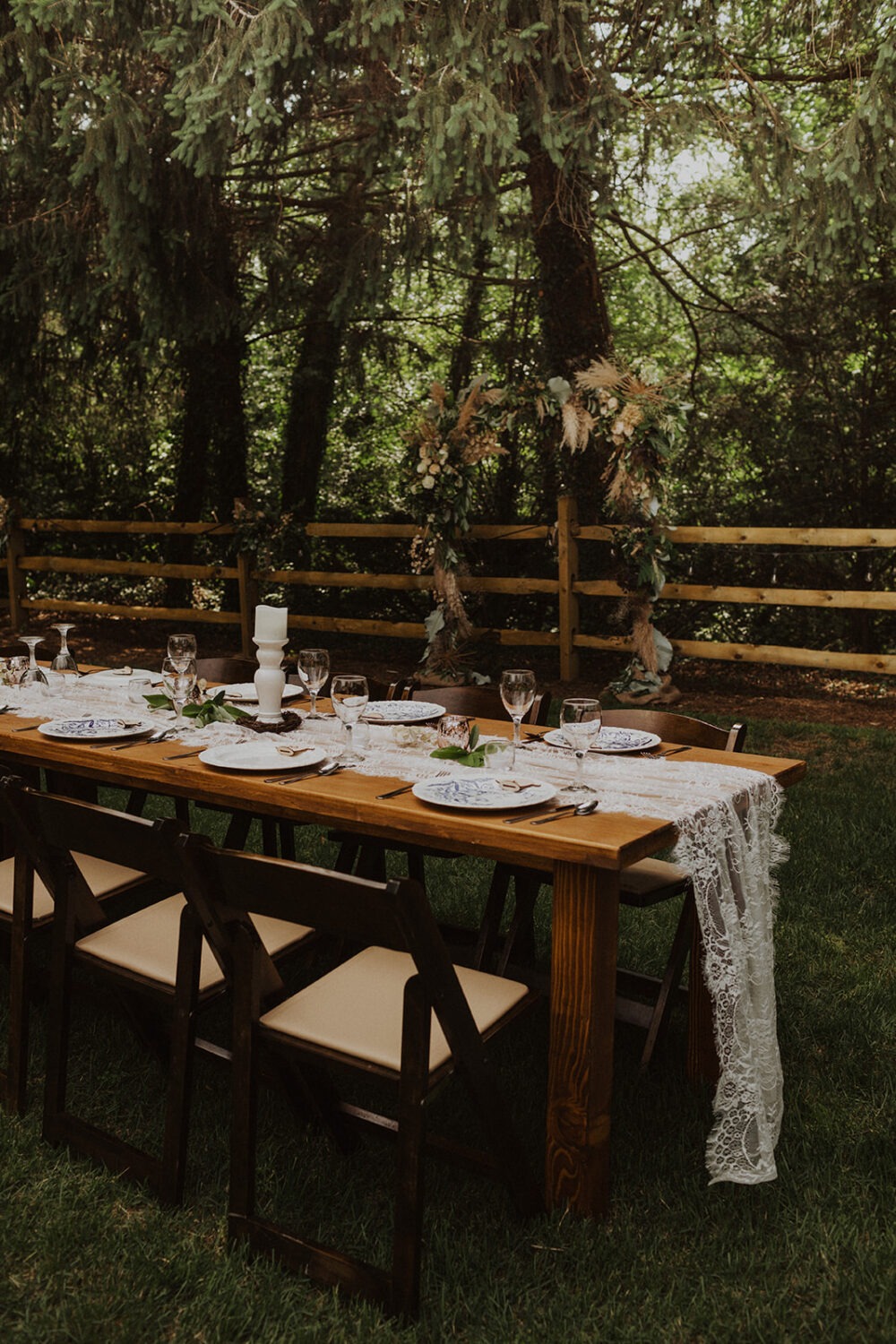 floral and lace table setting at backyard wedding