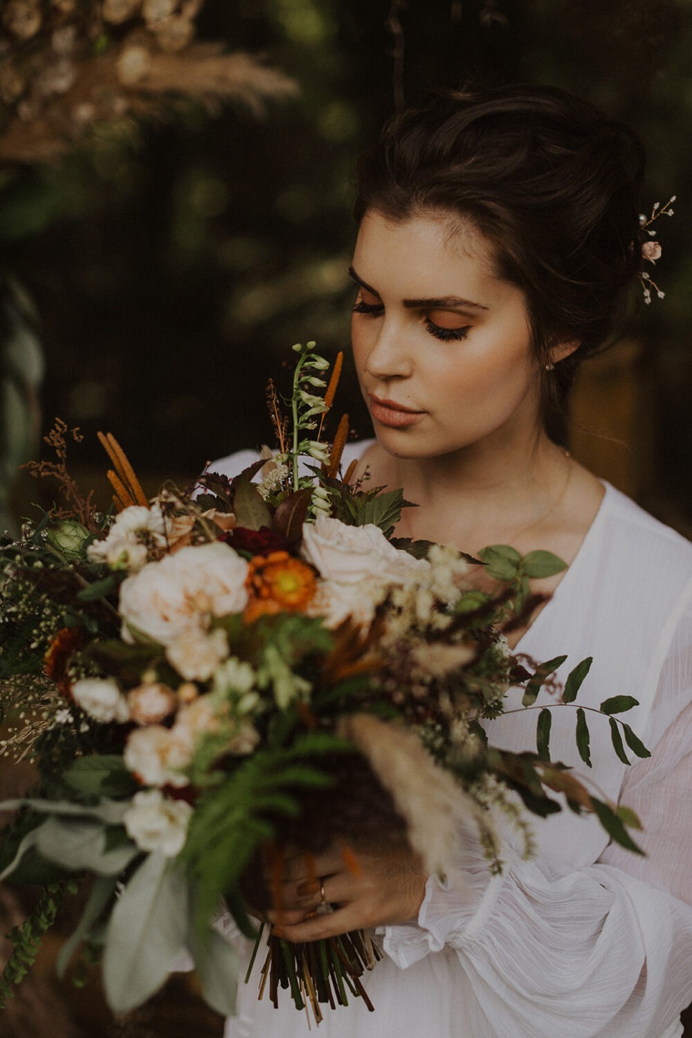 bride holds boho wildflower wedding bouquet
