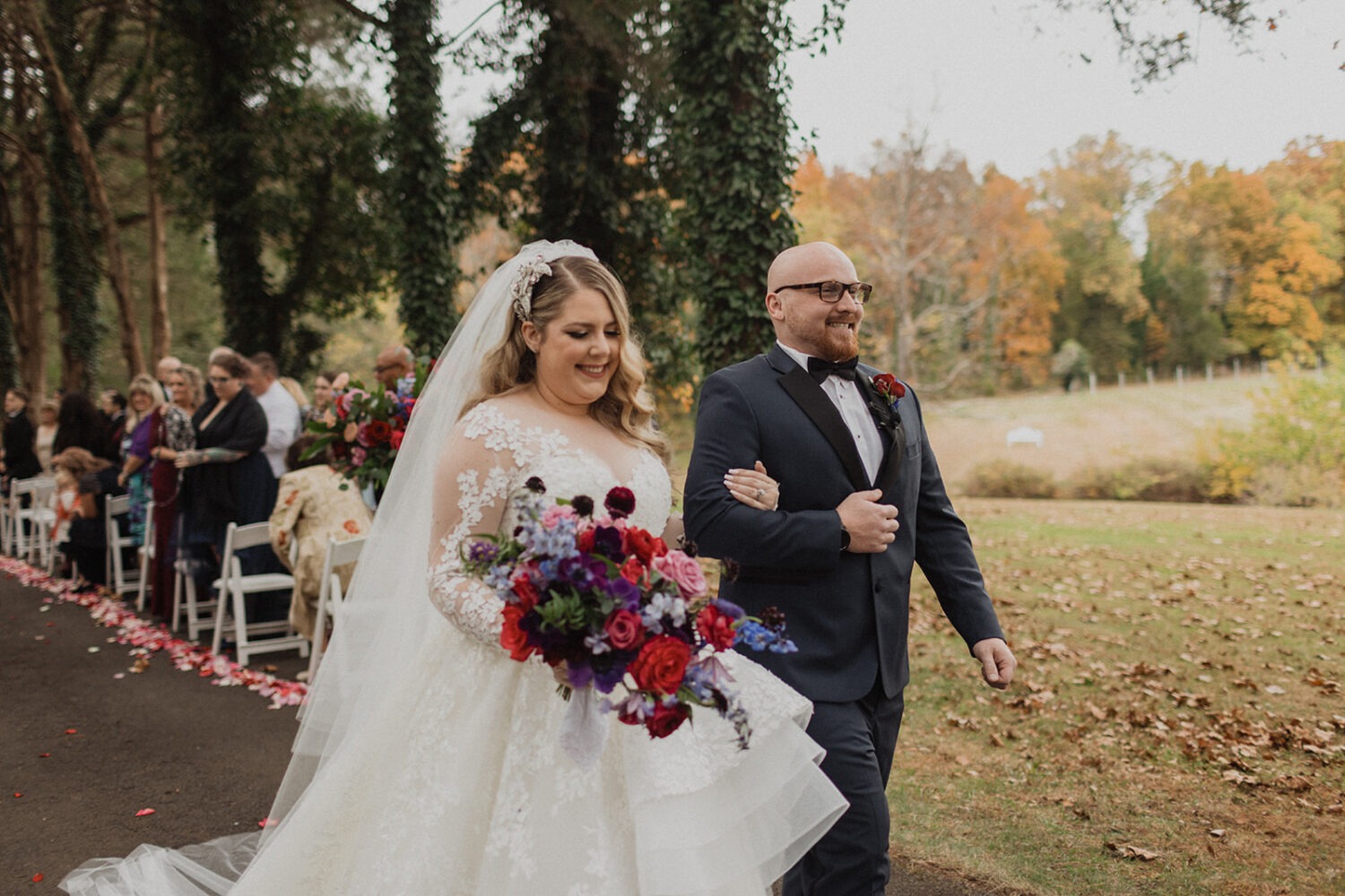 couple exits ceremony at outdoor fall Poplar Springs wedding