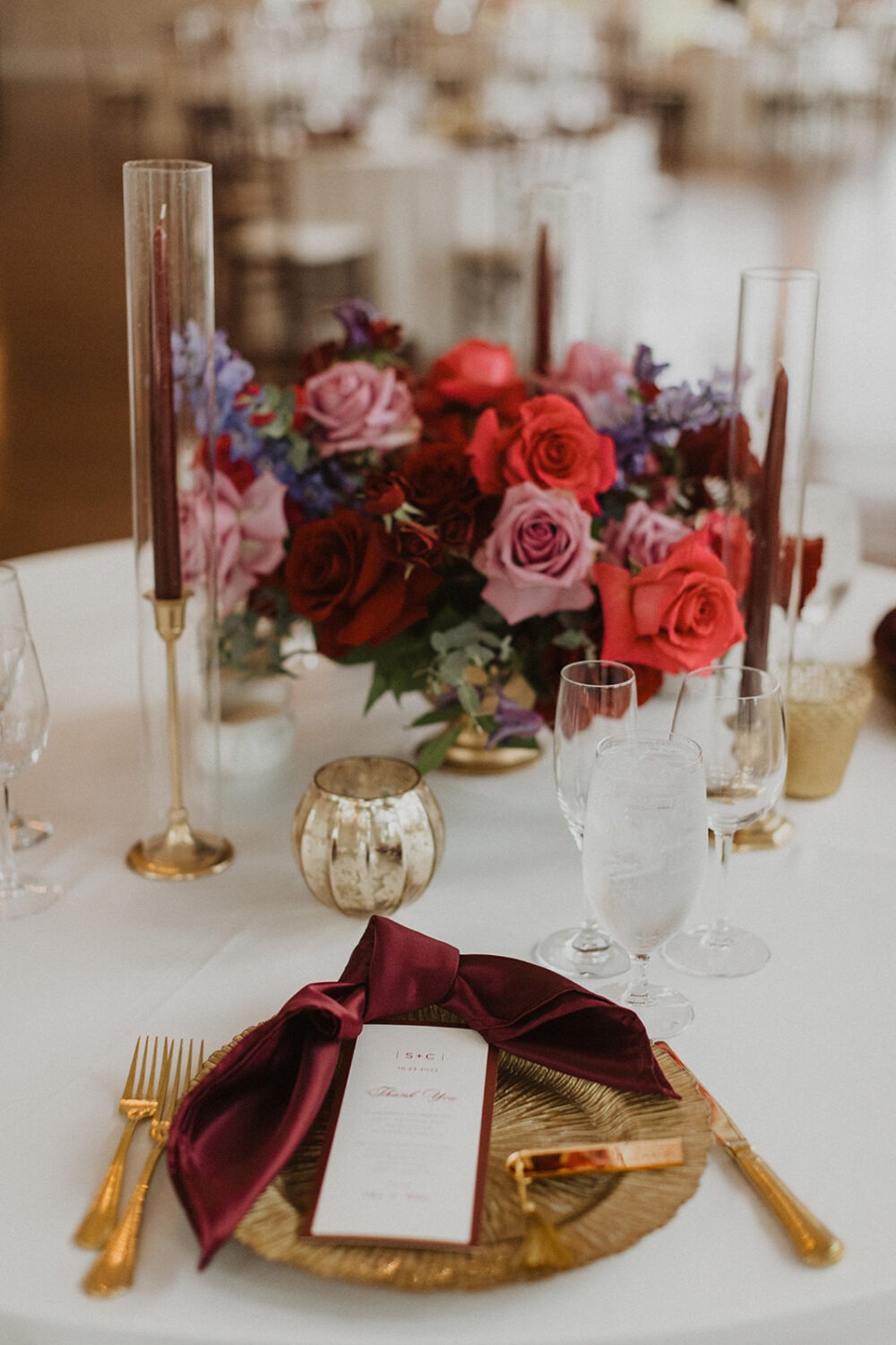 floral and gold wedding decor on reception table