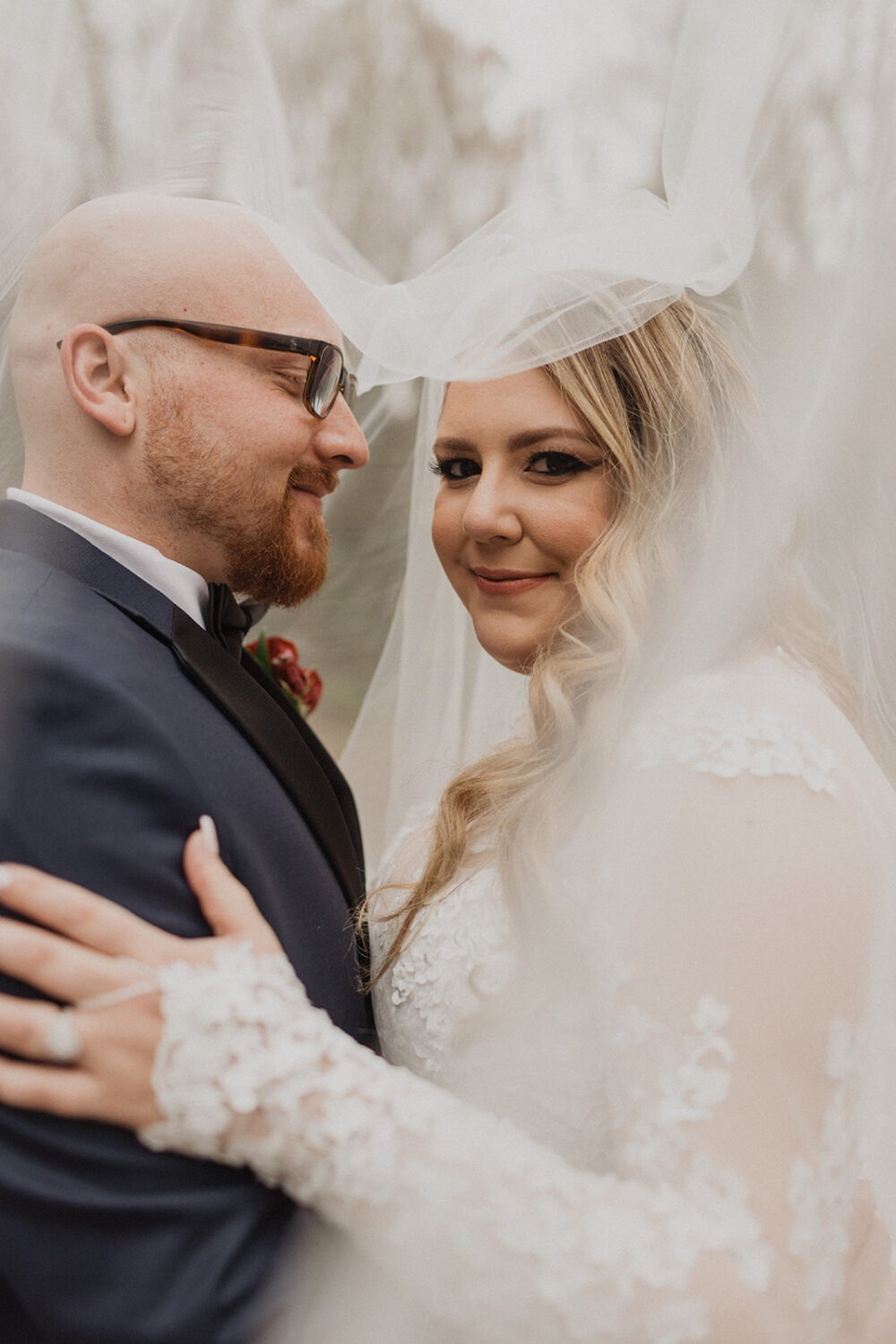 couple embraces under veil using wedding planning tips
