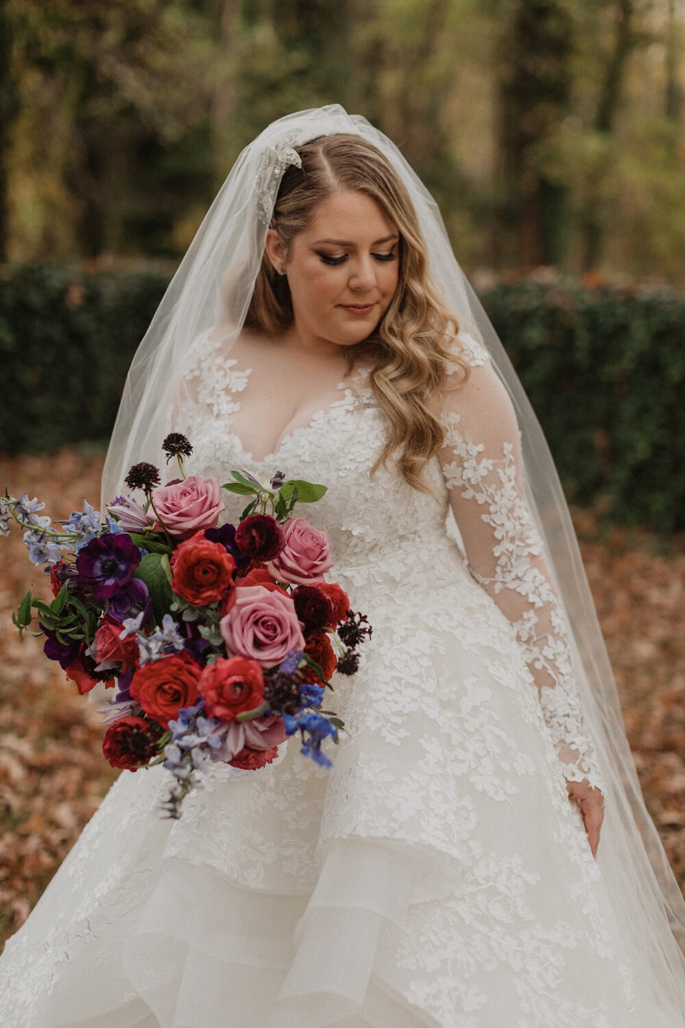bride holds red rose fall wedding bouquet