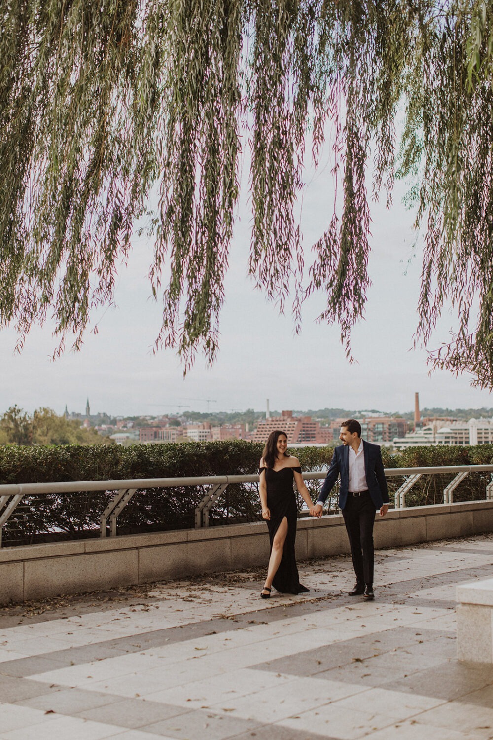 couple walks holding hands at Kennedy Center engagement session