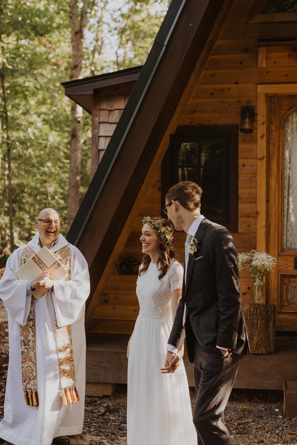 couple exchanges vows in front of a-frame cabin wedding venue