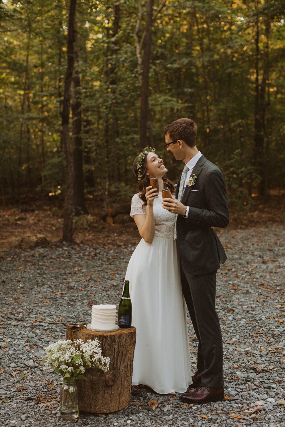 couple cheers at woods sunset elopement
