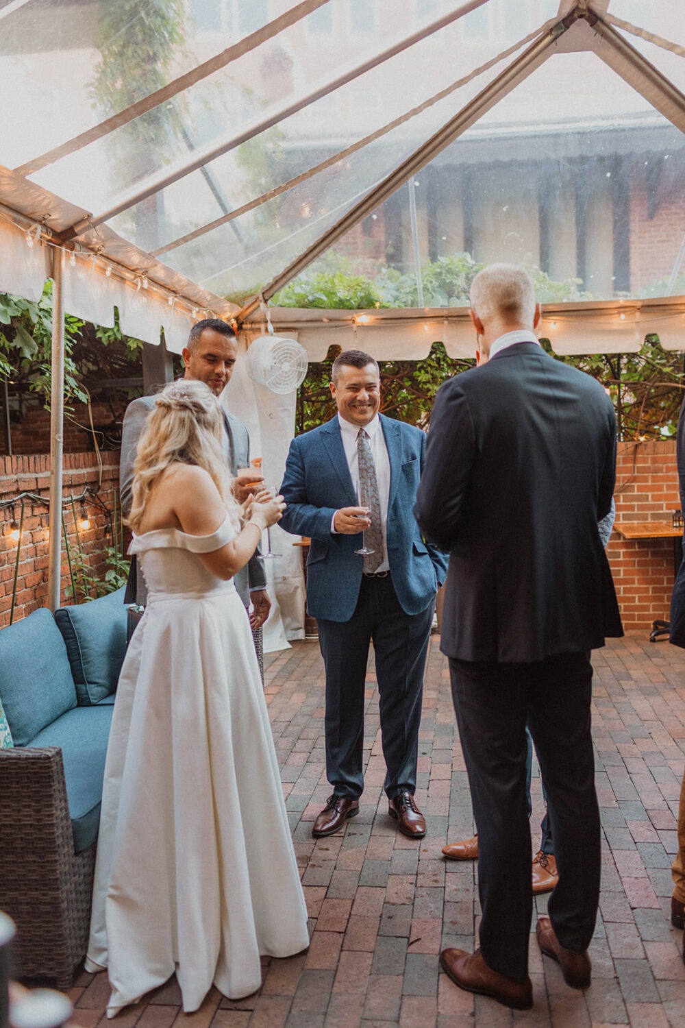 couple stands with guests at Iron Gate Restaurant DC intimate wedding