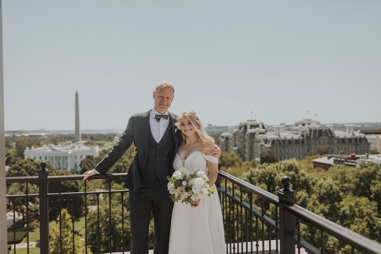 couple embraces at Washington DC rooftop intimate wedding