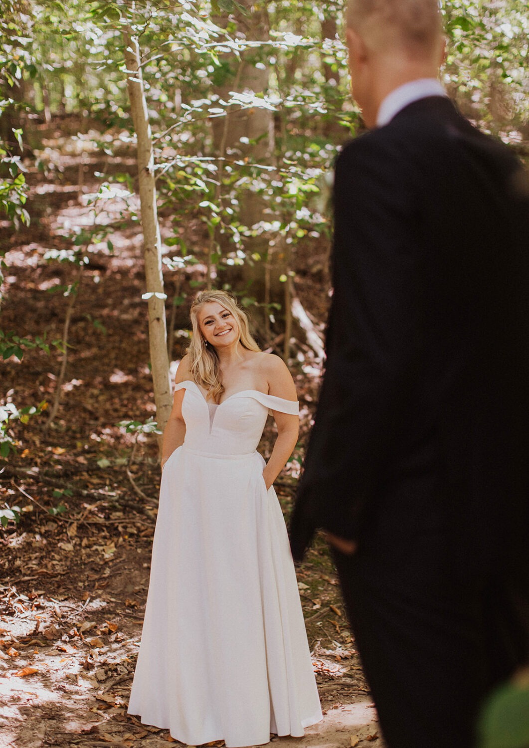 couple walks through forest at Rock Creek Park elopement