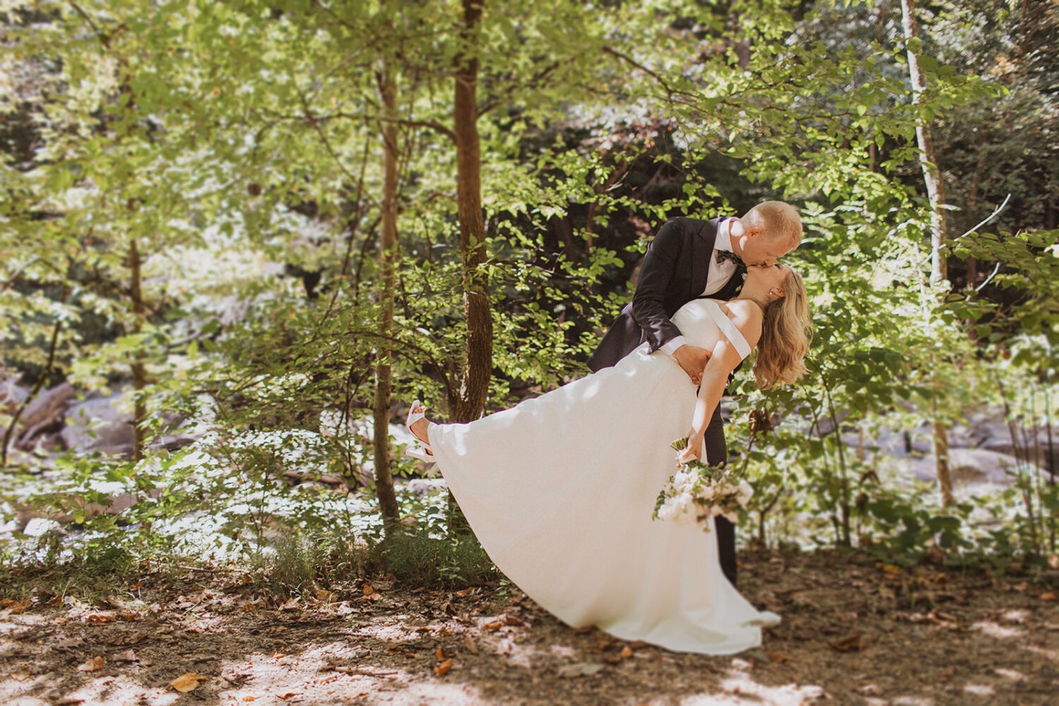 couple kisses in forest at Rock Creek Park elopement