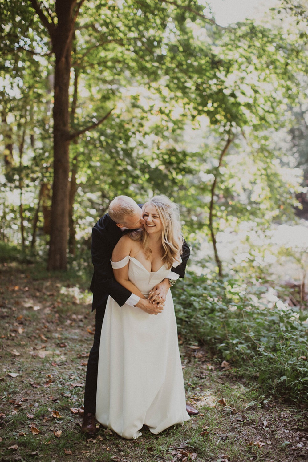 couple embraces in forest at Rock Creek Park elopement