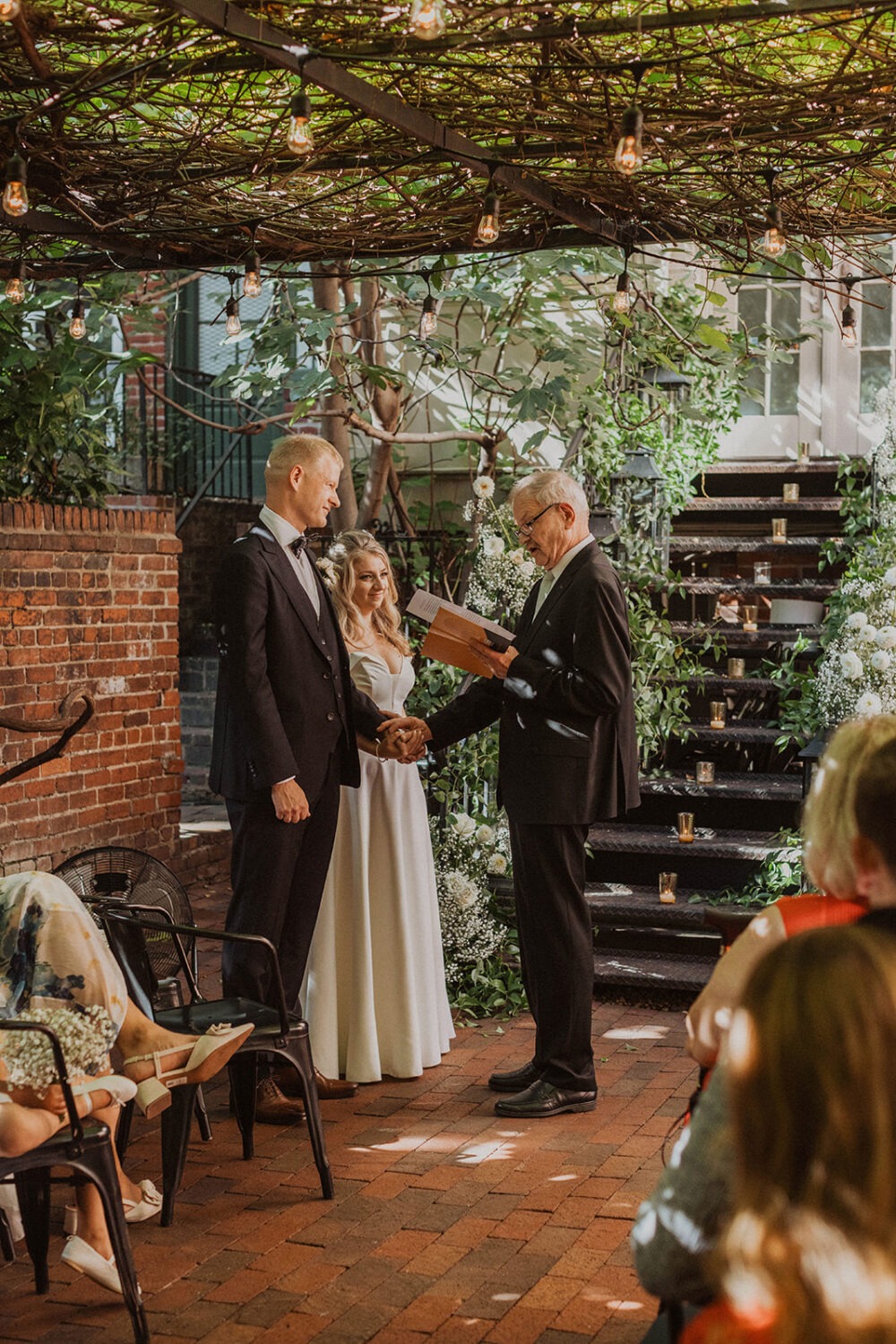 couple exchanges vows at Iron Gate Restaurant DC intimate wedding