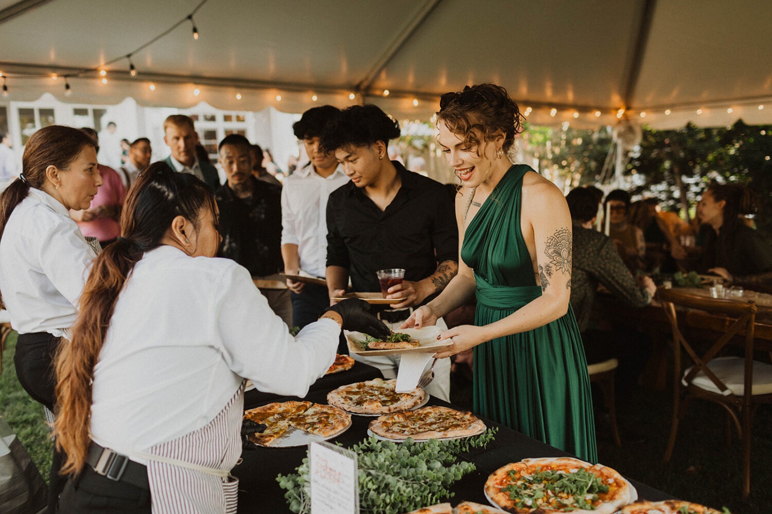 guests get pizza at wedding reception