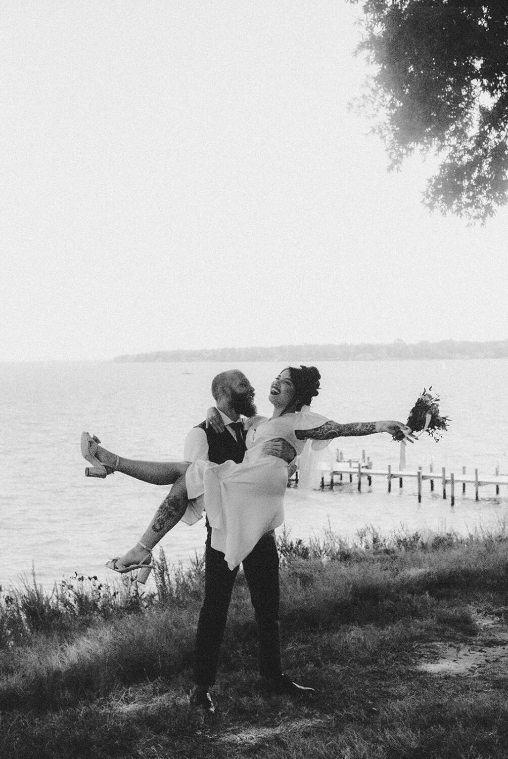 couple embraces at waterfront elopement captured by film wedding photography
