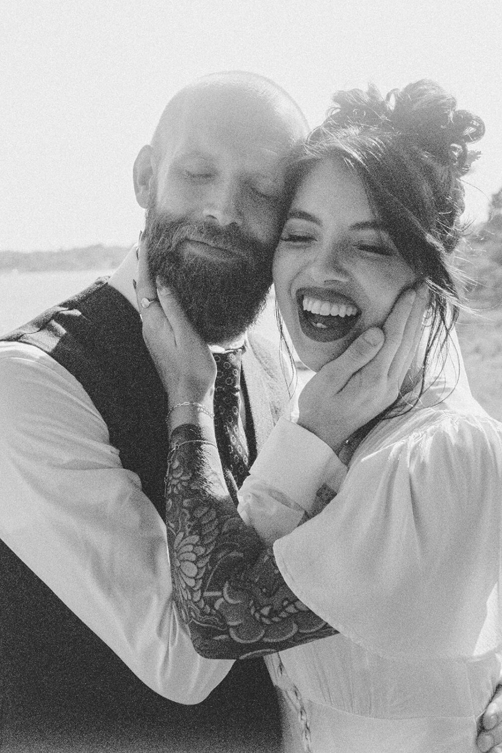 couple embraces face to face captured by film wedding photography