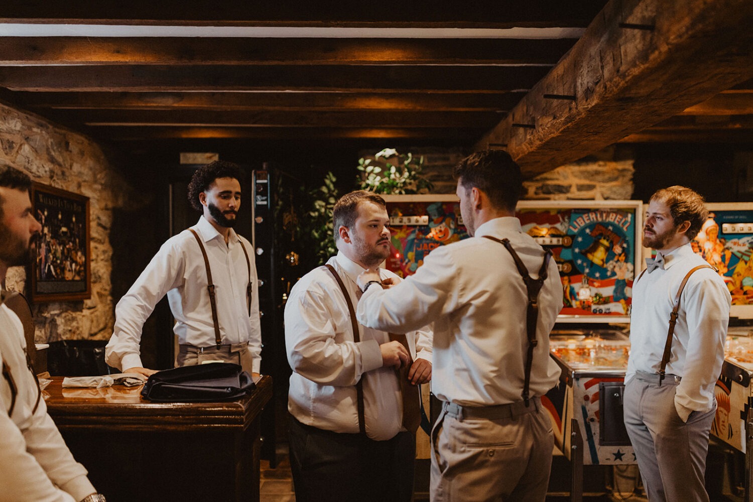groom gets ready with groomsmen in basement