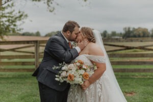 couple kisses at Walker's Overlook farm wedding venue
