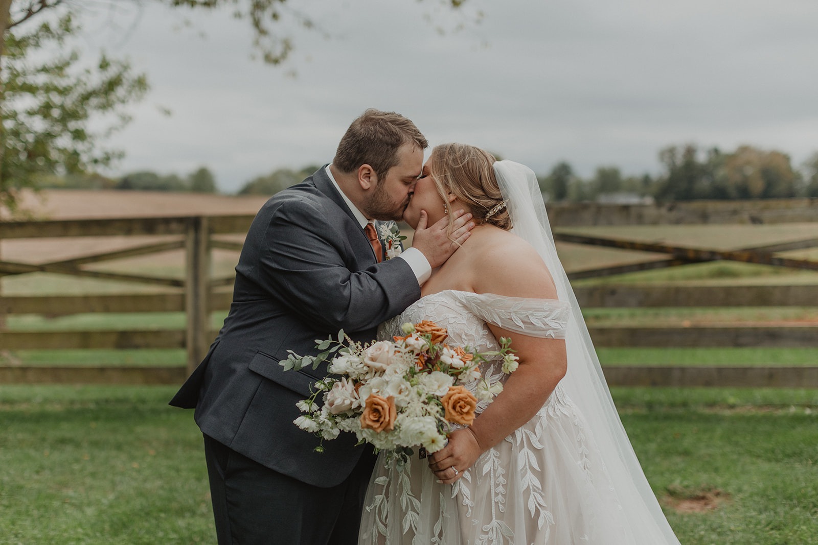 couple kisses at Walker's Overlook farm wedding venue